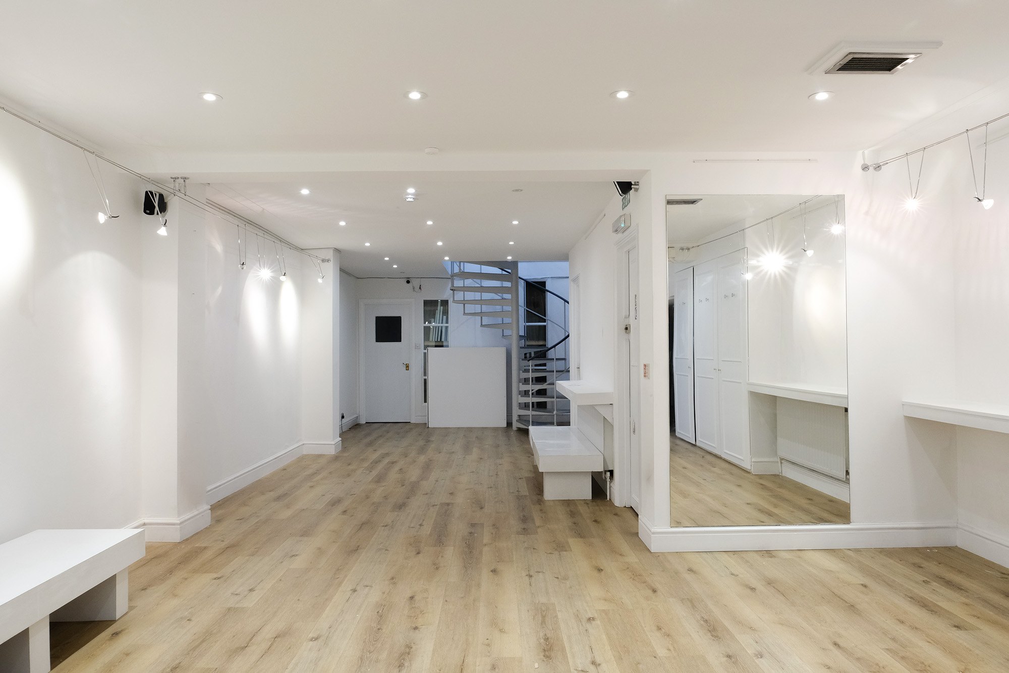 The full length of the bottom floor, with benches and gallery lighting