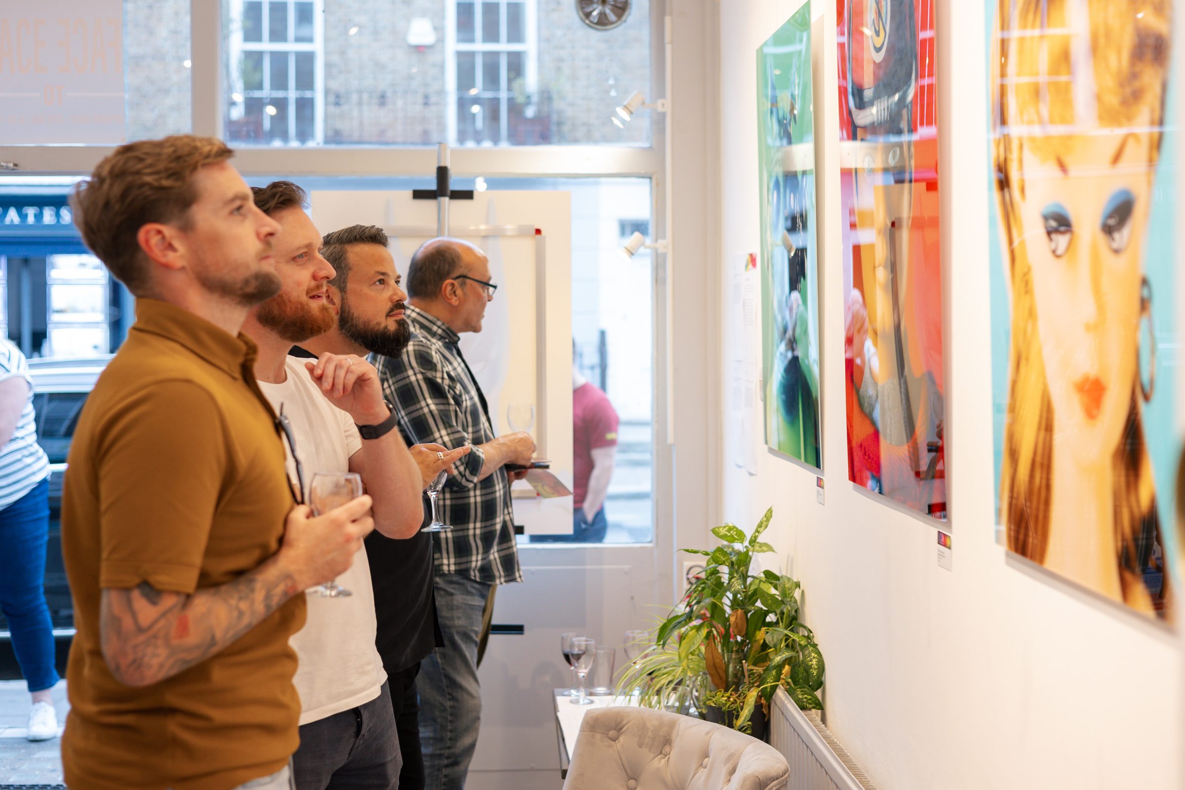 Visitors looking at artworks at an exhibition opening at London Contemporary Art
